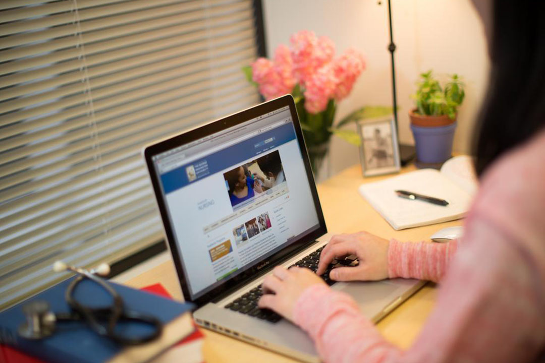 A person working at a laptop at a desk
